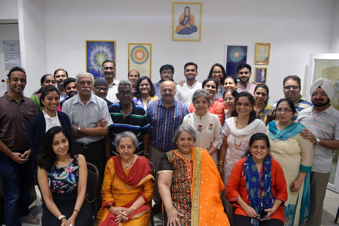 A large group of Divine Lotus community members gathered together at the center in 2018