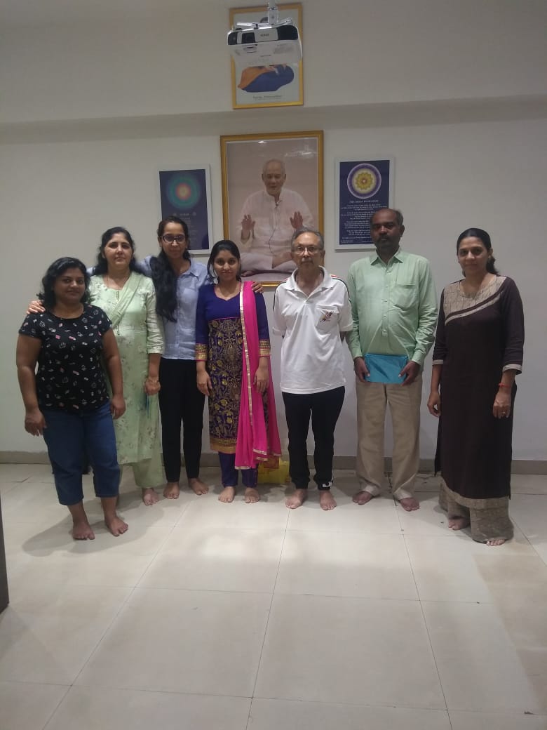 A course group standing together at the center after a session