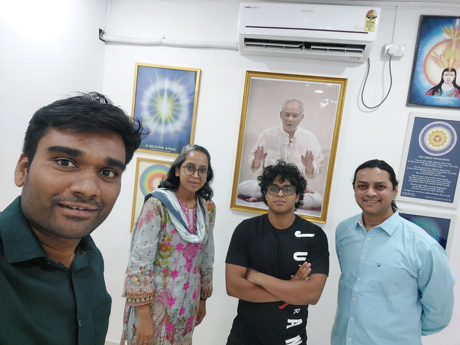 Four people together at the center, in front of the portrait of Grand Master Choa Kok Sui